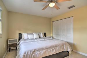 a bedroom with a bed with a ceiling fan at Cozy Indian Rocks Beach Condo - Steps to Beach! in Clearwater Beach