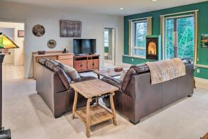 a living room with a leather couch and a television at Ketchikan Home Bay Views, half Mi to Hiking Trails in Ketchikan