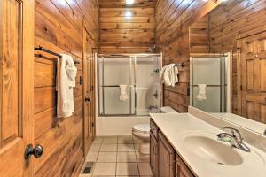 a bathroom with a sink and a shower and a toilet at Sevierville Cabin with Hot Tub and Large Deck! in McCookville +18 photos