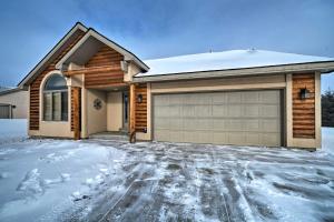 a house with a garage in the snow at Cozy and Convenient Red Lodge Home Less Than 8 Mi to Slopes! in Red Lodge