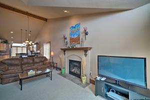 a living room with a large television and a fireplace at Cozy and Convenient Red Lodge Home Less Than 8 Mi to Slopes! in Red Lodge