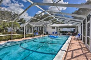 a swimming pool with a retractable canopy over it at Cottage with Private Pool - Walk to Lake Wales! in Lake Wales