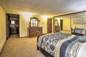 a bedroom with a bed and a dresser and a mirror at Lakefront Fairbanks Unit, 1 Mile to Pioneer Park! in Fairbanks