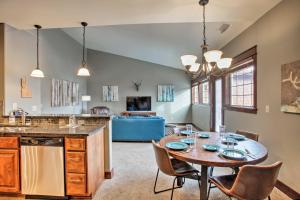a kitchen and dining room with a table and chairs at Coeur dAlene Condo - 2 Mi to Beach and Lake! in Coeur d'Alene