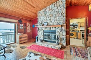 a living room with a stone fireplace in a house at Updated Cabin on 7 Acres - Day Trip to Lake Geneva in Burlington