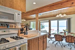 a kitchen with a stove and a table with chairs at Cedar Cottage, Private Beach on Lake Leelanau in Cedar