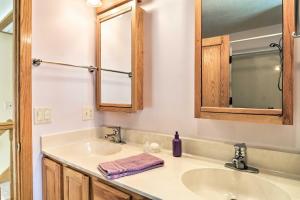 a bathroom with a sink and a mirror at Cedar Cottage, Private Beach on Lake Leelanau in Cedar +18 photos