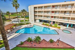 an empty pool in front of a hotel at Corpus Christi Beachfront Condo with Pool Access! in Corpus Christi