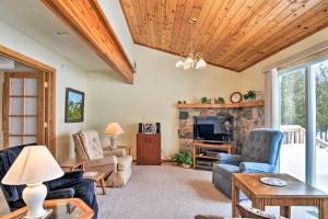 a living room with a couch and chairs and a tv at Cedar Cottage, Private Beach on Lake Leelanau in Cedar