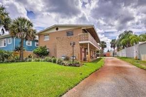 a house on a street with a grass yard at Condo-Walk to Daytona Beach, 6 Mi to Speedway in Daytona Beach