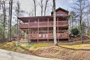 a large wooden house on a hill in the woods at Gatlinburg Mountain Cabin with Grill and Pool Table! in Gatlinburg