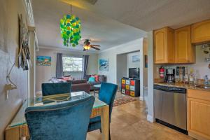 a kitchen and living room with a table and chairs at Condo-Walk to Daytona Beach, 6 Mi to Speedway in Daytona Beach