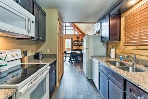 a kitchen with a sink and a refrigerator at Gatlinburg Mountain Cabin with Grill and Pool Table! in Gatlinburg