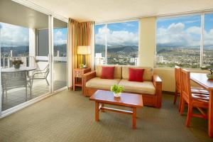 a living room with a couch and a table at Pacific Monarch Hotel in Honolulu +44 photos