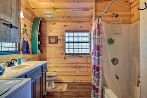 a bathroom with a shower and a sink at Arkansas Log Cabin Rental Near Lake Greeson! in Mount Moriah
