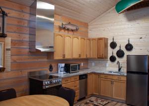 a kitchen with wooden cabinets and a pigs head on the wall at Denali Wild Stay - Moose Cabin, Free Wifi, 2 private bedrooms, sleep 6 in Healy