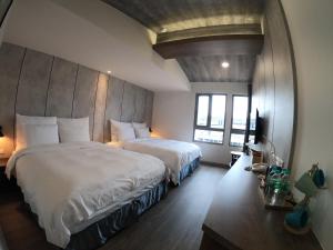 Postel nebo postele na pokoji v ubytování Watermark Hotel Kaohsiung Main Station