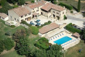 een luchtzicht op een huis met een zwembad bij Hotel Le Mas de Rivet in Barjac