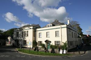 ein weißes Gebäude an der Ecke einer Straße in der Unterkunft The Junction Hotel in Dorchester