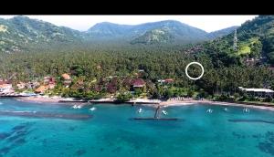 an aerial view of a resort in the middle of the water at Villa Rizki Candidasa in Candidasa