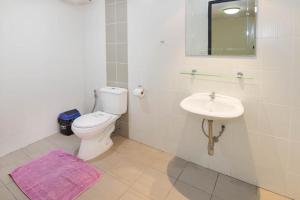 a bathroom with a white toilet and a sink at Villa Rosa with Private Pool and Jacuzzi 100m to beach in Pattaya South +9 photos