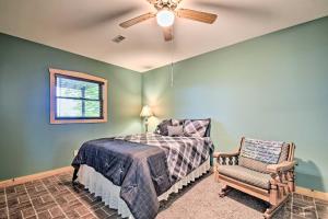 a bedroom with a bed and a chair at Cozy Amish Country Cabin on Shipshewana Lake! in Shipshewana