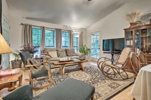a living room with a couch and a tv at Riverfront Martindale House with 2 Covered Decks in Martindale