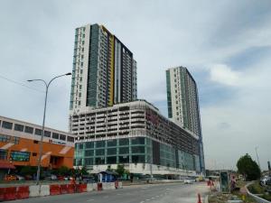 two tall buildings on the side of a street at hasanah evo studio suites in Kampong Sungai Ramal Dalam