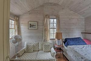a bedroom with a bed and a couch and a window at Cozy Vineyard Haven Cottage Less Than 1 Mi to Beach! in Vineyard Haven