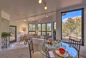 a living room with a glass table and chairs and a couch at Sedona Apartment with Private Patio and Red Rock Views in Sedona