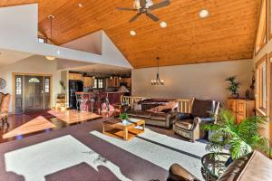 a large living room with a wooden ceiling at Cabin with Deck and Fire Pit, 9 Mi to Mt Rushmore! in Keystone