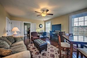 a living room with a couch and a table with a ceiling fan at Reading Apt, Walk to Shops, Dining and City Park! in Reading