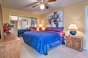 a bedroom with a bed and a ceiling fan at Balcony, Pool and Hot Tub Cozy Condo in Arkansas! in Lake Hamilton