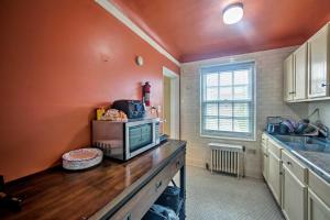 a kitchen with a counter with a microwave on it at Walk to Shops, Dining & City Park: Reading Apt in Reading