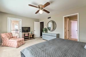 a bedroom with a ceiling fan and a chair at Balcony, Pool and Hot Tub Cozy Condo in Arkansas! in Lake Hamilton