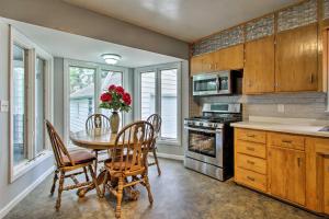a kitchen with a table and chairs and a kitchen with a stove at Rochester House with Yard - 5 Minutes to Mayo Clinic in Rochester