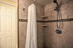 a shower with a white shower curtain in a bathroom at Hip Studio with Patio 1 Mi to Pompano Beach Pier in Pompano Beach +16 photos