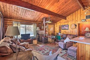 a living room with a couch and a tv at Walk to Lava Hot Springs Pools from Cozy Cabin! in Lava Hot Springs