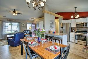 a kitchen and living room with a wooden table and chairs at Cozy Getaway with Yard and Patio 4 Mi to Hayden Lake! in Hayden