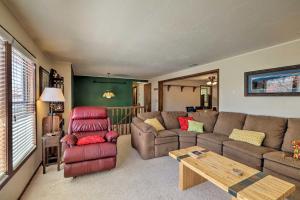 a living room with a couch and a table at Page Home with Balcony and Yard, Walk to Rim View Trail in Page