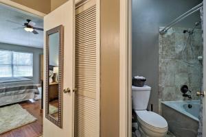 a bathroom with a toilet and a tub and a shower at Pet-Friendly Amelia Island Home about 1 Mi to Beach! in Fernandina Beach +16 photos