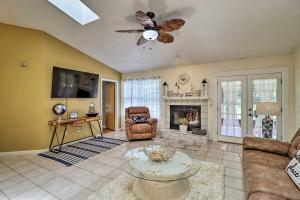 a living room with a ceiling fan and a fireplace at Pet-Friendly Amelia Island Home about 1 Mi to Beach! in Fernandina Beach