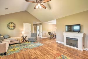 a living room with a fireplace and a flat screen tv at Dahlonega Home with Yard near Hiking and Downtown in Dahlonega