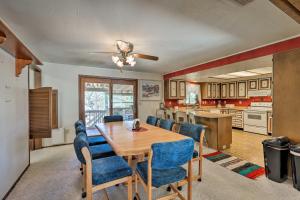 a kitchen and dining room with a table and chairs at Page Home with Balcony and Yard, Walk to Rim View Trail in Page
