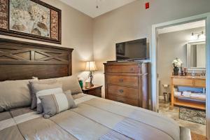 a bedroom with a large bed and a television at Sevierville Resort Retreat about 2 Mi to Pigeon Forge! in Pigeon Forge +16 photos