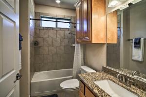 a bathroom with a toilet and a tub and a sink at Hill Country Casita with Patio 13 Mi to Dtwn Boerne in Kreutzberg +18 photos