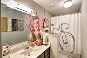 a bathroom with a bike on the wall next to a sink at Quiet Memphis Home on 20 Acres 10 Mi to Downtown! in Memphis +21 photos
