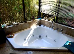 a large bath tub in a bathroom with a window at Riveresque in Margaret River Town