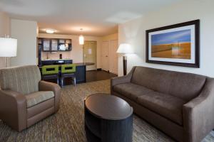 a living room with a couch and a table at Candlewood Suites Dickinson by IHG in Dickinson
