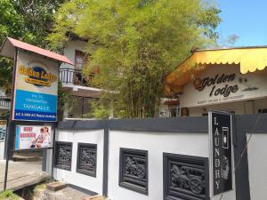 a building with signs on the side of it at Golden Lodge Tangalle in Tangalle